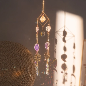Crystal suncatcher with aventurine and amethyst stones showing rainbow light refraction
