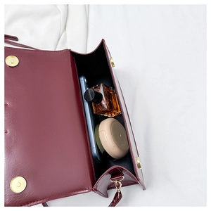 Interior view of wine red crossbody bag showing space for phone and cosmetics