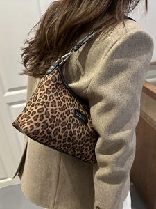 Chic leopard print tote bag with black leather trim and silver metal hardware