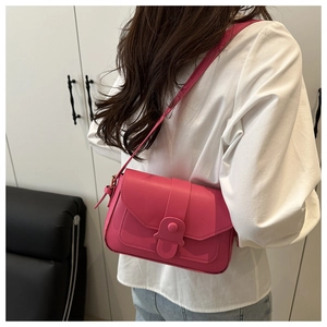 Detail of trendy rose red square crossbody bag with round buckle and adjustable strap