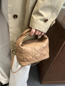 Beige quilted heart pattern handbag with top handle and crossbody strap for women