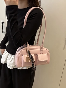 Pink faux leather shoulder bag with double front flap pockets and tennis racket charm