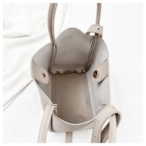 Close-up of pebble grain leather tote interior with golden magnetic snap closure