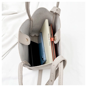 Internal view of large capacity pebbled leather tote bag with books and magnetic closure