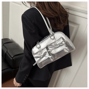 Silver Y2K bow shoulder bag shown on model for size perspective and sleek metallic look