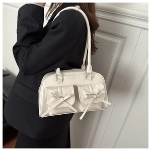 Detailed view of cream PU leather shoulder bag featuring two elegant bow pockets