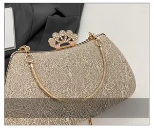 Detail of evening clutch featuring champagne lace, glitter, and a crystal crown clasp