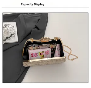 Detailed internal view of the gold evening clutch showing capacity for phone and cosmetics