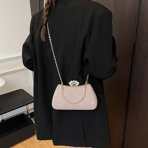 Elegant pink sequin evening clutch bag with gold chain strap and floral diamond clasp