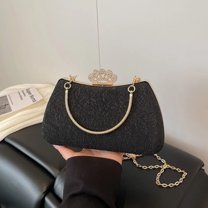 Detail of black sequined evening bag with golden frame and rhinestone crown clasp
