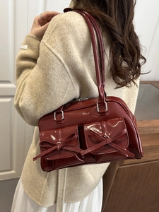 Burgundy patent leather shoulder bag with ballet style bows and double pockets