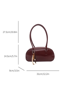 Minimalist burgundy underarm shoulder bag in glossy leather with wooden bead charm