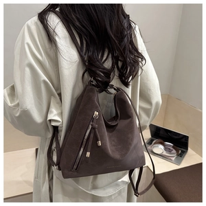 Rear view of model wearing a dark brown leather convertible hobo backpack for commuting