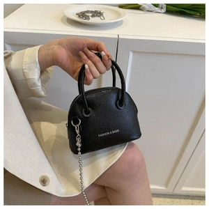 Detail of black lychee texture shell bag with silver chain strap and fashion printing