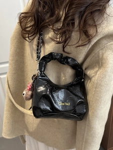 Black pleated patent leather handbag with silver chain and cute bear charm detail