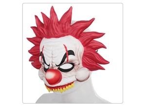 Detailed macro of scary Halloween clown mask with red hair and sharp yellow fangs