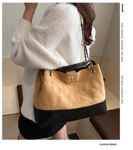Detail of vintage tote bag with brown suede finish and elegant gold chain strap