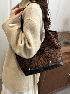 Stylish leopard print tote bag with black leather base and gold drawstring detail