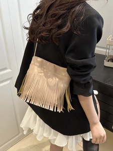 Chic beige crossbody bag with long tassels and minimalist faux leather rectangular design