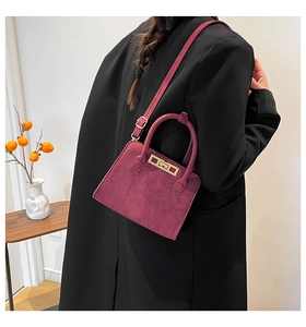 Detail of plum faux suede tote bag with vintage metal buckle and adjustable shoulder strap