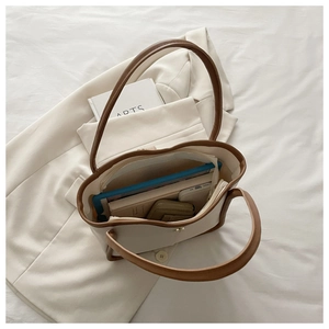Top view of spacious tote interior with laptop and phone, showing large capacity storage
