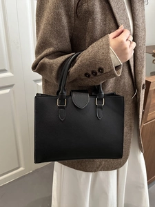 Classic black leather handbag with gold hardware for office and commuter style