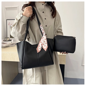 Detailed view of black PU leather tote bag set including inner pouch and polka dot silk scarf