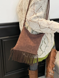 Brown vintage suede tassel shoulder bag for women styled with a bohemian outfit