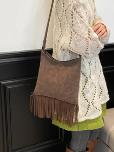 Exquisite dark brown fringe crossbody bag with vintage bohemian tassel design on suede texture