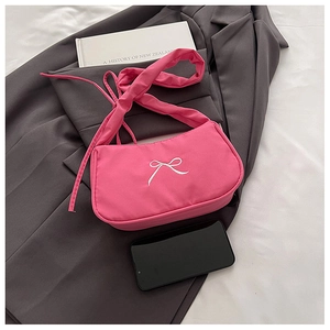 Pink nylon underarm bag featuring delicate white bow embroidery and knotted strap detail