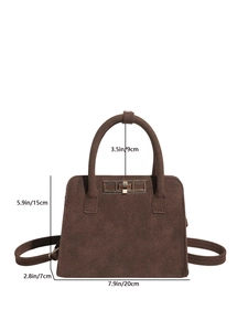 Deep brown matte suede handbag with metal buckle and shoulder strap in white background
