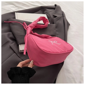 Detail of bright pink tote bag with white R embroidery and stylish ribbon drawstring