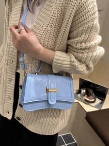 Chic light blue quilted leather handbag with gold H buckle and adjustable shoulder strap