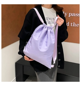Detailed view of light purple drawstring backpack made of shiny water-resistant nylon