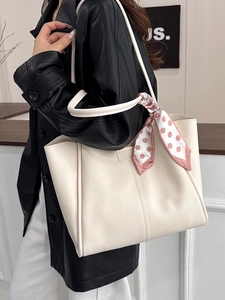Minimalist beige tote bag with a pink polka dot scarf shown on a model for daily commute