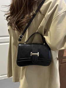 Classic black quilted crossbody handbag with gold hardware and flap closure for women