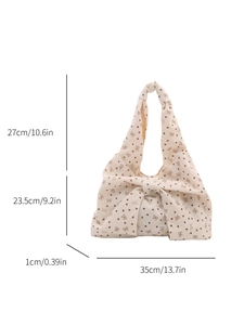 Cream shoulder bag with butterfly bow print and size details shown on white background