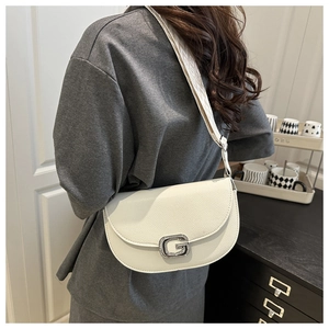 Chic beige lychee leather saddle bag featuring a rhinestone G buckle and wide strap