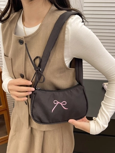Chic black nylon underarm bag with pink embroidered bows and adjustable shoulder strap