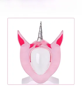 Detail of pink unicorn plush headwear with silver spiral horn for festive parties