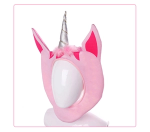 Close-up of pink plush unicorn hat with silver spiral horn and soft ears for party cosplay
