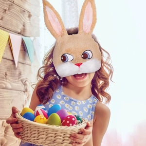Furry rabbit mask for Easter party with blue eyes and long ears worn by a young girl