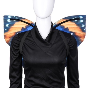 Detail of vibrant blue and orange butterfly wings with elastic straps on a mannequin
