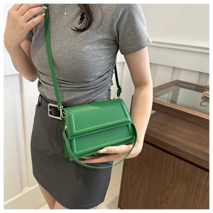 Minimalist bright green rectangular crossbody bag with sleek geometric stitching detail
