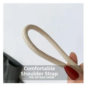 Close-up of the beige pebble leather shoulder strap with durable stitching details