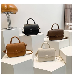 Detailed close-up of textured leather crossbody bags in four classic elegant colors