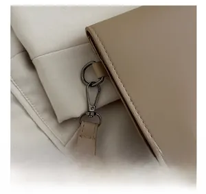 Detail of lychee pattern leather with gunmetal spring hook and elegant D-ring hardware