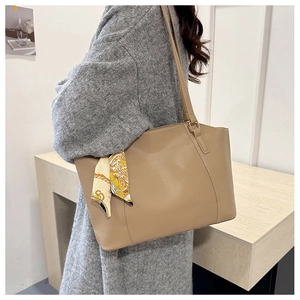 Chic beige leather tote bag with elegant printed scarf on thin shoulder straps