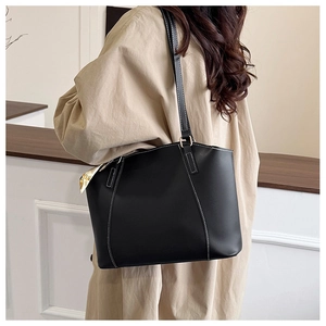 Close-up of black tote bag with white contrast stitching and decorative printed silk scarf
