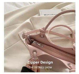 Detail view of pink bucket bag showing zipper closure and interior fabric lining